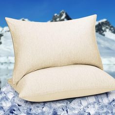 a pillow sitting on top of a pile of ice cubes next to a mountain