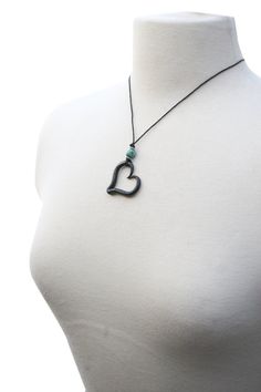 "Iron Heart Necklace, Hand Forged Iron, Blacksmith, Heart Necklace, Boho Necklace, Iron Jewelry, Iron Anniversary Gift This Blacksmith made heart necklace is finished off with an African turquoise bead and 2 silver beads. Hung from soft cotton cording and hooked with a lobster clasp. The length of the necklace cord is approximately 18\". The heart measures approximately 1.25 inches across. Each heart is handmade by me in a coal forge, shaped on the anvil, brushed, and finished with wax to preven Adjustable Heart Pendant Necklace With Heart Beads, Adjustable Heart Necklace With Heart Beads And Pendant, Adjustable Heart Beads Pendant Necklace, Adjustable Double Heart Necklace With Heart Beads, Black Open Heart Charm Necklace, Black Open Heart Necklace With Heart Charm, Handmade Adjustable Black Heart Necklace, Coal Forge, Iron Anniversary Gifts