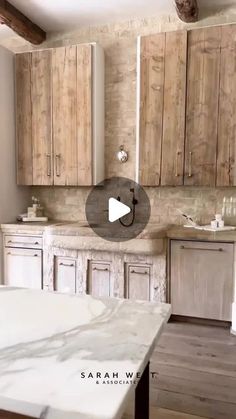 a kitchen with white marble counter tops and wooden cabinetry, along with a video about how to install the cabinets