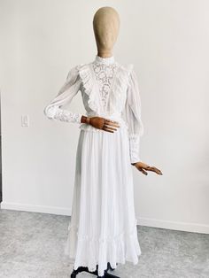 "GUNNE SAX WHITE COTTON GAUZE DRESS Circa 1970s, highly rare and collectible Perfect for a bohemian bride Soft, angelic white cotton gauze Fully lined with subtle sheerness Lace detail adorns bodice and neckline Maxi length skirt with ruffle trim  Full zip closure down back Long sleeves with button closure at wrists Incredible vintage condition, structurally sound and wearable as is. Due to age and delicate nature of fabric, some standard signs of wear are to be expected. No major flaws to note! Tagged size 3 Bust flat 17\" Waist flat 11.5\" Shoulders across 15\" Sleeve length 19\" Full length 51\" 2 business day handling time, USPS Priority Mail is standard. International shipping available! Buyer is responsible for shipping costs. ALL ITEMS SOLD AS IS. Due to the delicate nature of pre l White Floor-length Victorian Dress With Ruffles, White Fitted Victorian Dress Floor-length, Elegant White Floor-length Vintage Dress, White Fitted Vintage Victorian Dress, White Victorian Prairie Dress For Wedding, White Victorian Prairie Dress, Elegant White Vintage Maxi Dress, Elegant White Maxi Vintage Dress, White Fitted Victorian Prairie Dress