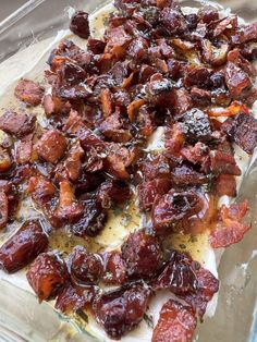 bacon on top of cheese in a glass baking dish, ready to go into the oven