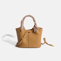 Elevate your fashion game with our exquisite 2023 Brand Bucket Bag Leather Bag. Crafted to perfection, this high-end masterpiece combines timeless French retro aesthetics with modern elegance, creating a cross-body handbag that's truly a work of art. Immerse yourself in luxury with the finest leather that not only exudes sophistication but also promises durability, ensuring your investment lasts for years to come. The intricate sweet stitching adds a touch of whimsy to the classic design, making a bold statement wherever you go. This handbag isn't just an accessory - it's a statement piece that embodies both style and functionality. The spacious interior offers ample room for your essentials, keeping you organized without compromising on style. The cross-body design provides comfort and co Luxury Classic Crossbody Bucket Bag, High-end Luxury Bucket Bag, Luxury High-end Leather Bucket Bag, Luxury High-end Crossbody Bucket Bag, High-end Luxury Leather Bags, Light Luxury Square Shoulder Bag, Elegant Square Bucket Bag, Formal Beige Bucket Bag With Large Capacity, Beige Large Capacity Bucket Bag For Formal Occasions