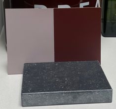 several different colors of marble on display in a store window or showroom, including red, pink, purple and black