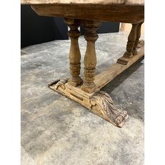 an old wooden table that has been turned into a dining room table with two legs