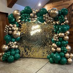 a green and gold mirror frame with balloons on the wall behind it in front of some wood paneling