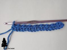 the crochet hook is being used to make an afghan