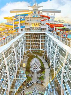 an aerial view of the inside of a cruise ship with water slides in the background