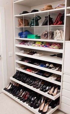 a white closet filled with lots of shoes