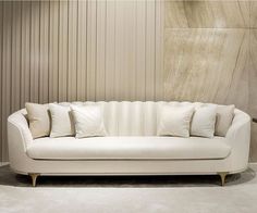 a white couch sitting in front of a wall