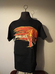 Metallica Shirt  - 1994©️ licensed to Giant graphic  - Burning skull front graphic  - Sun skul on fire back graphic  - Metallica spell out  - Artimode tagged  Size: L  Great vintage condition  No rips or holes  No stains Vintage Shirt With Front Print For Fans, Vintage Skull Print Tops For Streetwear, Band Merch Shirt With Skull Print For Streetwear, Band Merch Skull Print Shirt For Streetwear, Metallica Vintage, Metalica Tshirt Vintage, Metalica Shirt, Vintage Metallica Shirt, Metallica Shirt