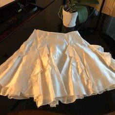 This New Without Tags Midi Skirt Is A Gorgeous, Shiny 100% Silk . Beautiful, Designer, Layered Skirt With A Side Zipper. Skirt Measures 20” Long, Waist Measures About 26”. Gorgeous Off White Color. Silk Fitted Skirt With Ruffles, White Pleated Skirt For Summer Party, White Pleated Skirt For Party, Elegant Lined Mini Skirt For Spring, Elegant Mini Skirt With Ruffled Detail, Elegant Tiered Mini Skirt With Lining, Elegant Mini Skirt For Spring, Elegant Tiered Lined Mini Skirt, Elegant Pleated Mini Bottoms