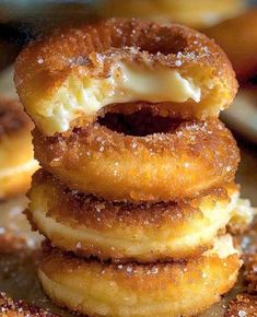 several donuts stacked on top of each other with icing and powdered sugar