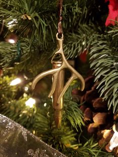 a gold ornament hanging from a christmas tree