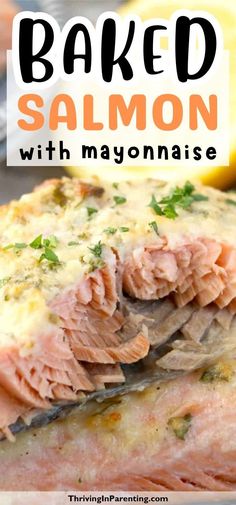 baked salmon with mayonnaise and parsley on the side, in front of lemon wedges