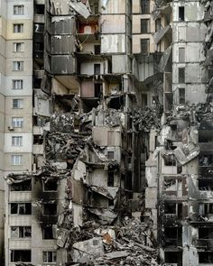 a very tall building with lots of windows and debris on the ground in front of it