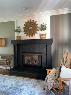 a living room with a fire place and chairs