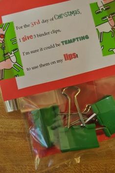 a pair of green clips sitting on top of a wooden table next to a sign