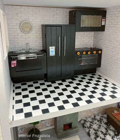 a doll house kitchen with black and white checkered flooring