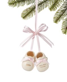 a pair of baby's shoes hanging from a christmas tree