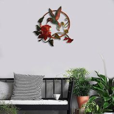 a living room filled with furniture and lots of plants on top of the floor next to a white wall