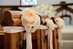 the flowers are placed on the pews at the wedding ceremony