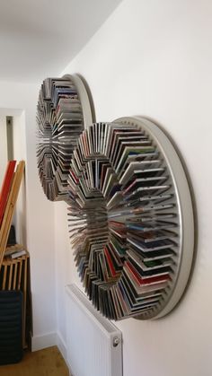 there are two circular bookshelves on the wall next to a radiator