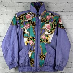 Vintage 1993 Sunterra Windbreaker Track Jacket Purple Flower Gold Petite Womens. Welcome To Project Perseverance! Brand: Sunterra Size: Ps Condition: Excellent Vintage Pre-Owned Condition Color/Pattern: Nice Light Purple Color With Gold And Floral Pattern. In Great Condition. No Shoulder Pads. Measurements: - Pit To Pit (Across Chest):~ 21” - Length (Top Of Collar To Hem):~25 ” -Sleeve (Shoulder To Cuff): ~ 26.5“ Thank You For Shopping With Project Perseverance! Condition Notes And Buying Proced Spring Floral Print Streetwear Outerwear, Retro Purple Outerwear For Spring, 90s Style Long Sleeve Spring Outerwear, 90s Spring Outerwear, Retro Floral Print Winter Outerwear, Purple Floral Print Long Sleeve Outerwear, Vintage Multicolor Outerwear For Spring, Vintage Fitted Long Sleeve Windbreaker, Vintage Multicolor Spring Outerwear