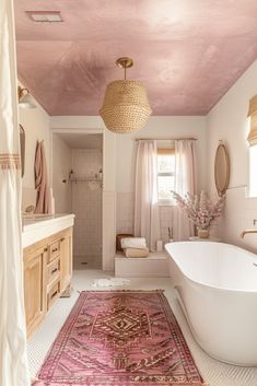 a bath room with a tub a sink and a rug