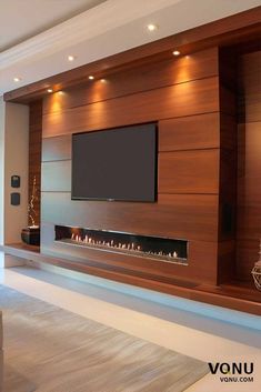 a living room with a flat screen tv mounted on the wall and a fireplace in front of it