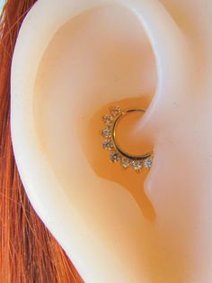 a woman's ear is shown with a ring on it