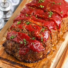 meatloaf with marinara sauce on a cutting board