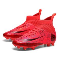 a pair of red nike soccer cleats on a white background