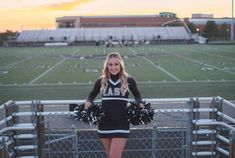 a cheerleader standing on the bleachers with her pom poms