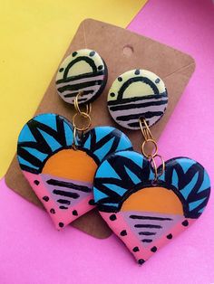 Introducing the abstract Alice Heart-shaped Hand-painted Earrings. These earrings are painted by hand, making each pair truly one-of-a-kind. The abstract design adds an interesting twist to the classic heart shape and creates a beautiful contrast of colours. Hand-painted onto natural wood, designed and crafted using acrylic paint and resin. The lightweight construction ensures comfort for all day wear. Trendy Multicolor Hand Painted Jewelry, Hand Painted Resin Earrings, Artistic Hand Painted Earrings For Summer, Hand Painted Resin Earrings In Artsy Style, Hand Painted Heart Earrings For Gift, Artistic Hand Painted Summer Earrings, Hand Painted Multicolor Heart Earrings As Gift, Hand Painted Multicolor Heart Earrings For Gift, Artsy Hand Painted Colorful Earrings