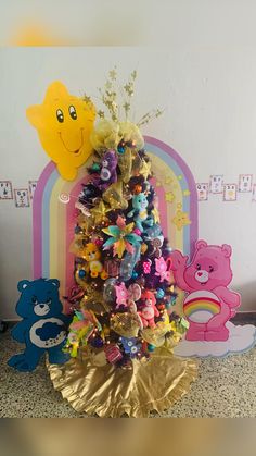 there is a small christmas tree decorated with colorful candies and teddy bears on it