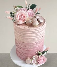 there is a pink cake with flowers on it