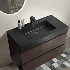 a bathroom sink sitting under a round mirror