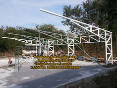 an outdoor structure that is being constructed in the middle of construction with people working on it