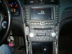 the inside of a car with dashboard controls and steering wheel, including an entertainment system