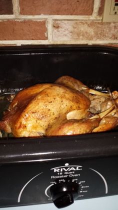 a roasting chicken in an oven on the stove