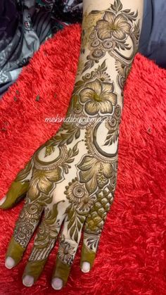 henna tattoo designs for hands and feet with flowers on the hand, which is decorated with