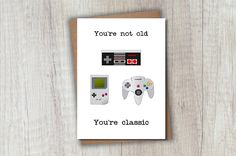 a card that says you're not old, you're classic and two game controllers