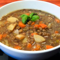 a white bowl filled with meat and vegetables