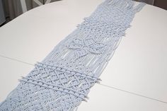 a close up of a white surfboard on a table with an intricate design in the middle