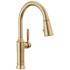 the kitchen faucet is shown in gold with an angled spout and side spray