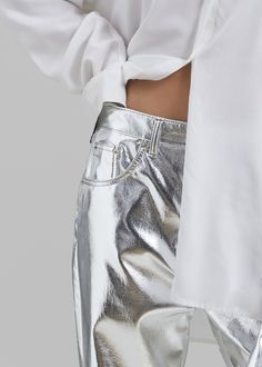 Color: Silver Midweight aluminium fabric Regular fit Straight leg Slant hip pockets Back patch pockets Belt loops Button fly Front button closure Unlined 100% Aluminium Dry Clean BY The Frankie Shop. Imported Chic Bottoms With Button Closure And Straight Hem, Modern Metallic Straight Leg Pants, Shiny Wide Leg Bottoms For Spring, Wide Leg Shiny Bottoms For Spring, Spring Wide Leg Shiny Bottoms, Metallic Shiny Straight Leg Bottoms, Metallic Wide Leg Bottoms With Pockets, Metallic Straight Leg Pants With Five Pockets, Metallic Wide Leg Bottoms For Work