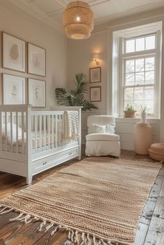 a baby's room with white furniture and pictures on the wall