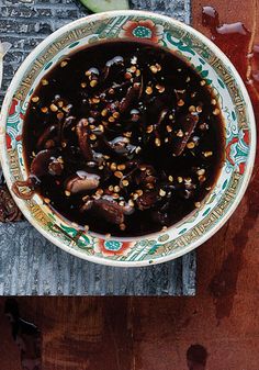 a bowl filled with food sitting on top of a wooden table