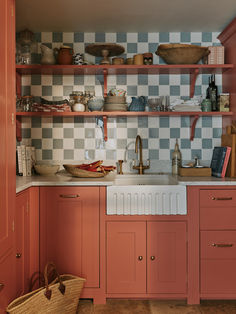 a kitchen filled with lots of counter top space next to a basket on the floor