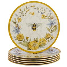 four plates with yellow flowers and a bee painted on the front one is stacked up